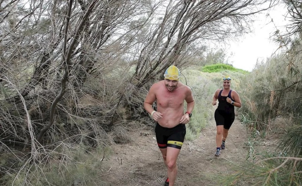 Runners tackling volcanic trails in Swimrun Tenerife 2025 race.